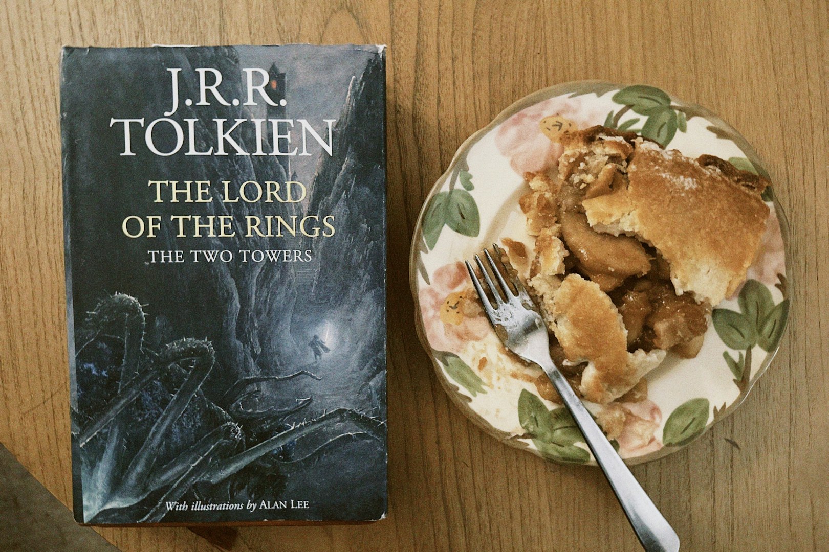 The lord of the rings book next to apple pie.